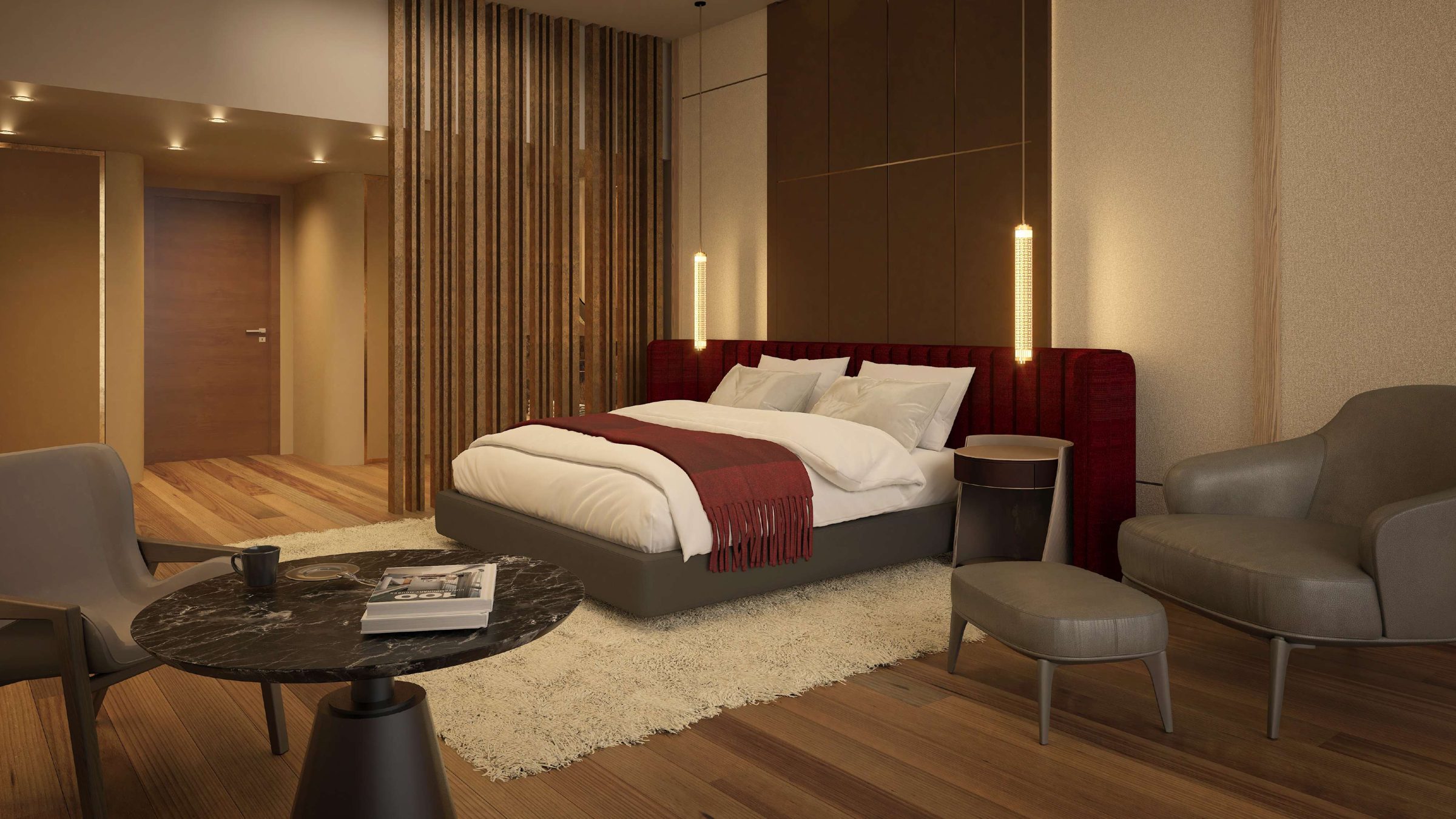 Suite con pisos de madera, sillones de cuero gris y lámparas colgantes doradas